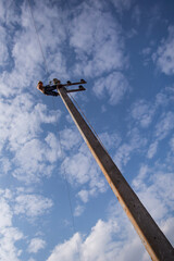 Man working on the top electric pole