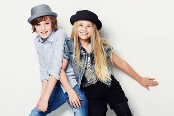Never too young to look trendy. Shot of two playful kids in a studio.