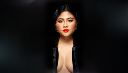 Asian 20s Woman chubby wear black fur jacket Red lips and freckles over black dark background