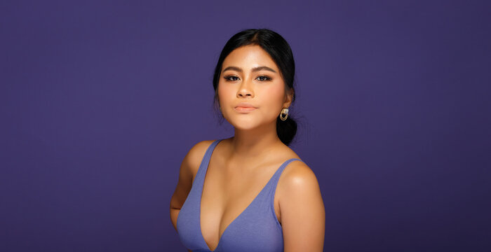 Asian 20s Woman chubby wear sport bra in purple color Very Peri world trend over purple background