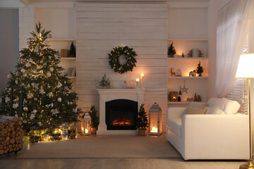 Stylish living room interior with decorated Christmas tree and comfortable sofa
