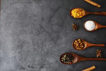 Wooden spoons with spices. A mixture of peppers and spices. Fragrant herbs for food.