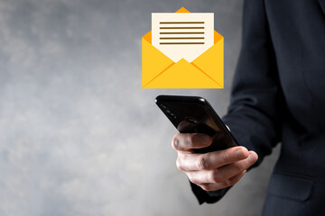 Businessman hand holding e-mail icon, Contact us by newsletter email and protect your personal information from spam mail. Customer service call center contact us concept