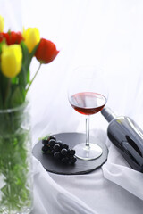 Glass with grape red semi-dry wine. Valentine's day concept background. Gift for the holiday. Sweet sparkling wine.
