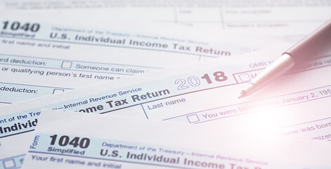 Annual tax reporting. Tax form on the table. Financial statements for signature.