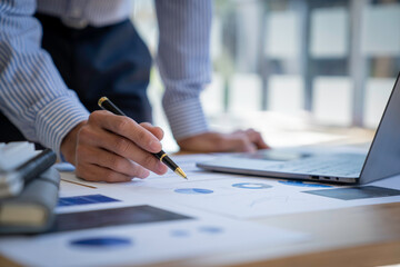 Businessman sitting at a desk financial data analysis and market growth report graph and investment results, analytical concepts and financial investments.