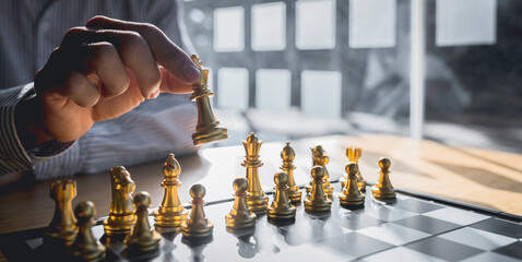 Businessman playing chess game reaching to plan a strategy for success, thinking for planning...