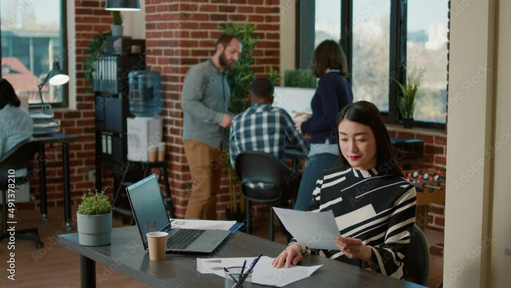 Poster portrait of smiling worker looking at cv information on paper to talk to applicant about executive j