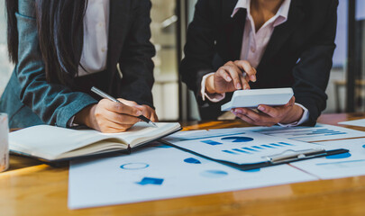Business team discussing financial report professionals having a meeting. The diverse group of coworkers discusses new decisions, Creative meetings,s and workplaces, business, finance, teamwork.