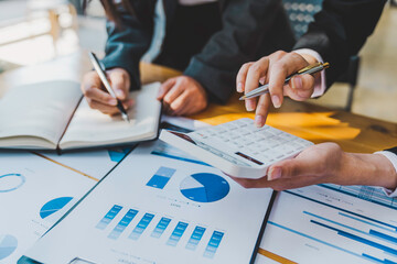 Business team discussing financial report professionals having a meeting. The diverse group of coworkers discusses new decisions, Creative meetings,s and workplaces, business, finance, teamwork.