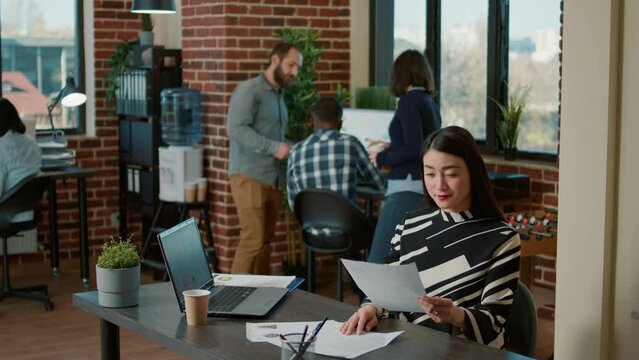 Portrait of smiling worker looking at cv information on paper to talk to applicant about executive jov interview and vacancy. Cheerful recruiter using resume to choose candidate for hiring.