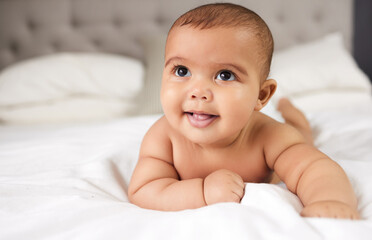 A babys laugh is like an angels voice. Shot of an adorable baby boy on the bed at home.