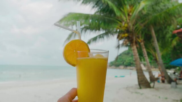 lemon juce on the beach sea coast shore or orange fresh juice summer surf wave background refreshing drink relax positive mood vacation