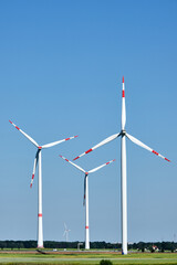 Wind energy plants in Germany in front of a blue sky 