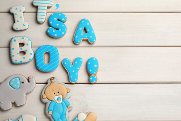 Phrase It is a boy, tasty cookies and space for text on white wooden table, flat lay. Baby shower party