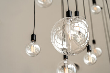 Modern interior light bulbs on the high white ceiling, round shape hanging light bulbs, blank space, worm eye view image