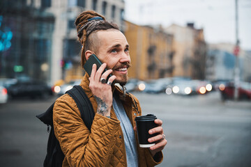 Smiling young man making call in city centre
