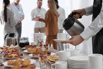 Waitress pouring hot drink during coffee break, closeup - Powered by Adobe