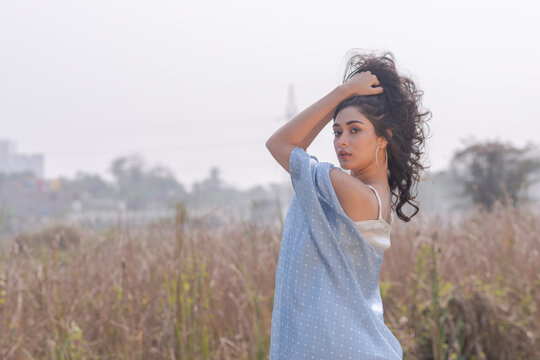 Beautiful Young Fashion model posing outdoor  in Resort Wear