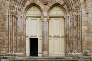 Fototapeta na wymiar Symmetrical Ivory catholic doors of a church