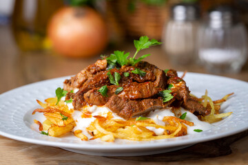 Turkish food; Cokertme Kebab - Beef meat kebab with yoghurt and french fries