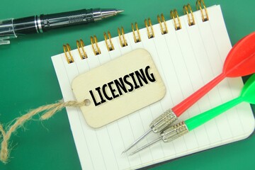 arrows, notebooks, pens and wooden tags with the word licensing