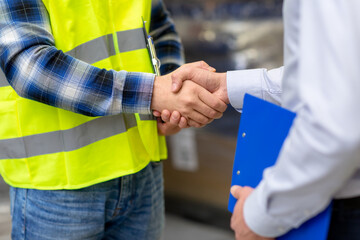 logistic business and cooperation concept - close up of manual worker and businessman with...