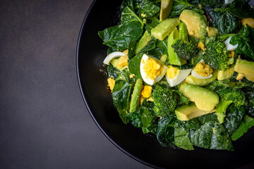 Avocado salad with broccoli, boiled egg in white vintage bowl on light salad