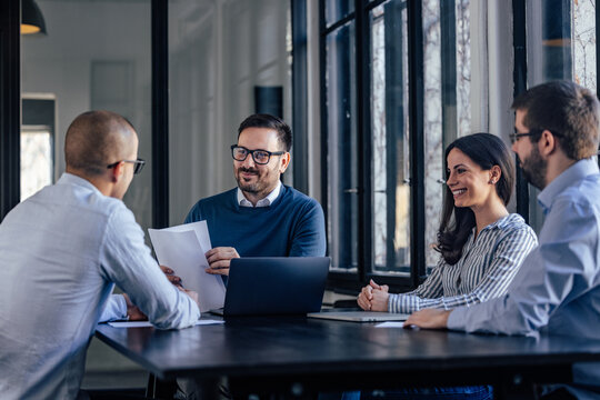 Excited caucaisan business parters, starting their company meeting in the morning.
