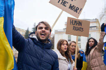 Group of young caucasian people manifesting against Ukrainian war