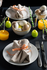 easter, holidays, tradition and object concept - close up of dinner party table serving over black background