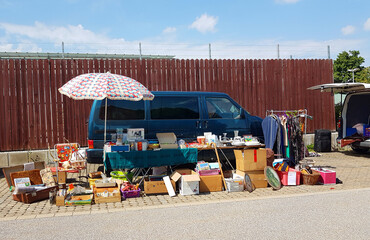 flea market stand with car and lots of old things to sale