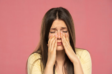 Sinus pain, sinus pressure, sinusitis. Sad woman holding her nose because sinus pain - obrazy, fototapety, plakaty