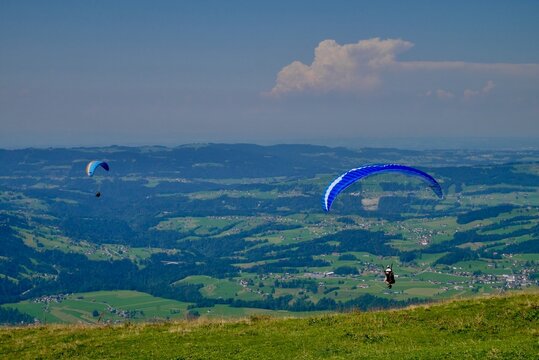 Paragliders taking off at Niedere in Bregenzerwald. Vorarlberg, Austria.