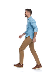 Fototapeta premium casual bearded guy with chino pants looking to side and smiling