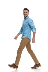 sexy middle aged man with sneakers smiling and walking