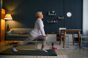 Retired woman enjoy home fitness in living-room