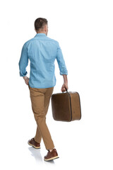 back view of casual guy with baggage travelling