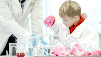 a student in a chemical laboratory conducts chemical sweats with chemical elements