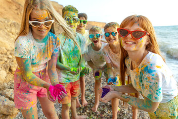 Children play in nature. Holi colors. High quality photo