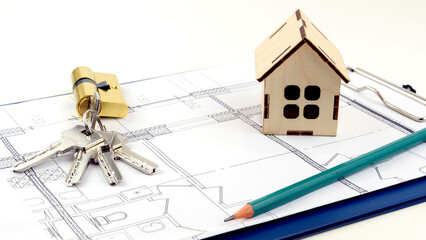 keys and the layout of the house on the drawings. the concept of buying and building housing