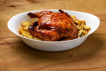 fried chicken meat and roasted potatoes, tasty food on a wooden background
