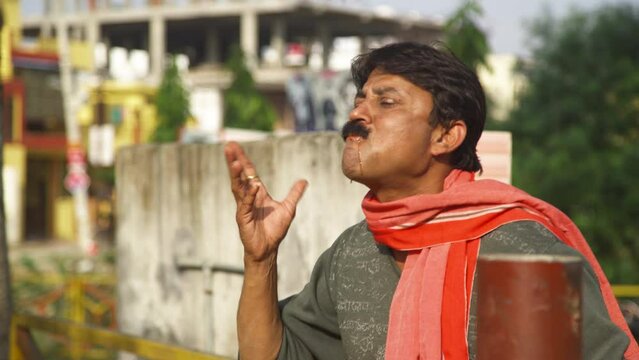 An Indian Man chewing tobaccos and trying to talk. High quality 4k footage