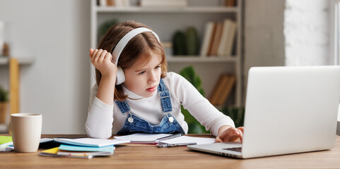 Confused child doing homework at home