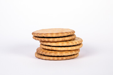 Cookies with chocolate filling in a pile on a white background