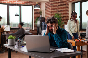 Pensive doubtful businessman brainstorming ideas working at marketing project in startup office....