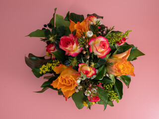 Basket of flowers on a pink background. Beautiful bouquet of flowers.