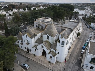 Aerial view of Alberobello, city of Trulli in Itria Valley, Puglia. Traditional Apulian dry stone...