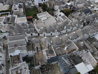 Aerial view of Alberobello, city of Trulli in Itria Valley, Puglia. Traditional Apulian dry stone huts with a conical roof in the Murge area of the Italian region of Apulia. Trulli city in south Italy