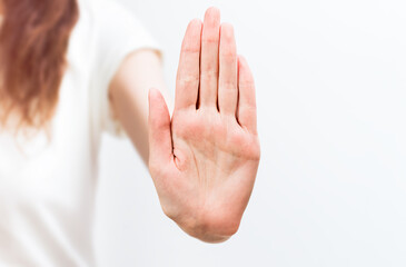 woman showing stop gesture on light background
